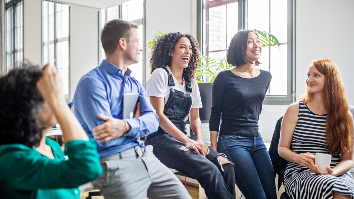 Group of young professionals chatting in an office.