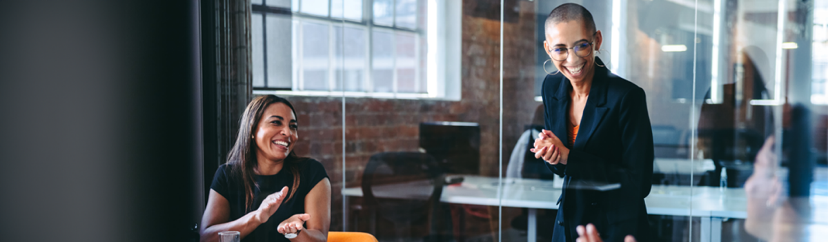 Employees laugh together in a meeting